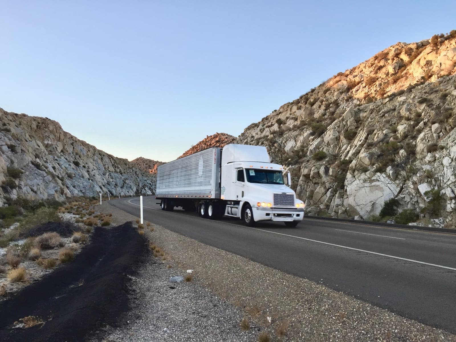 A commercial truck on the highway, representing the daily work of CDL drivers
