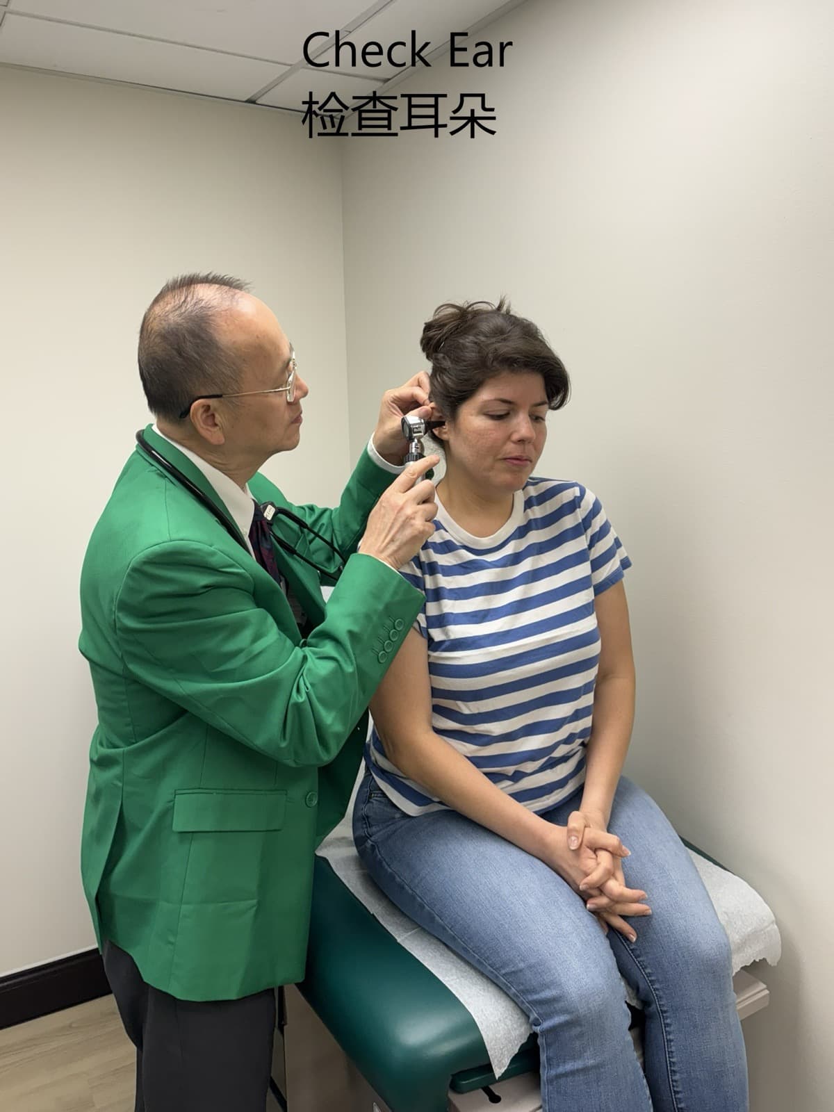 Dr. Lee examining a patient’s ear during a routine physical