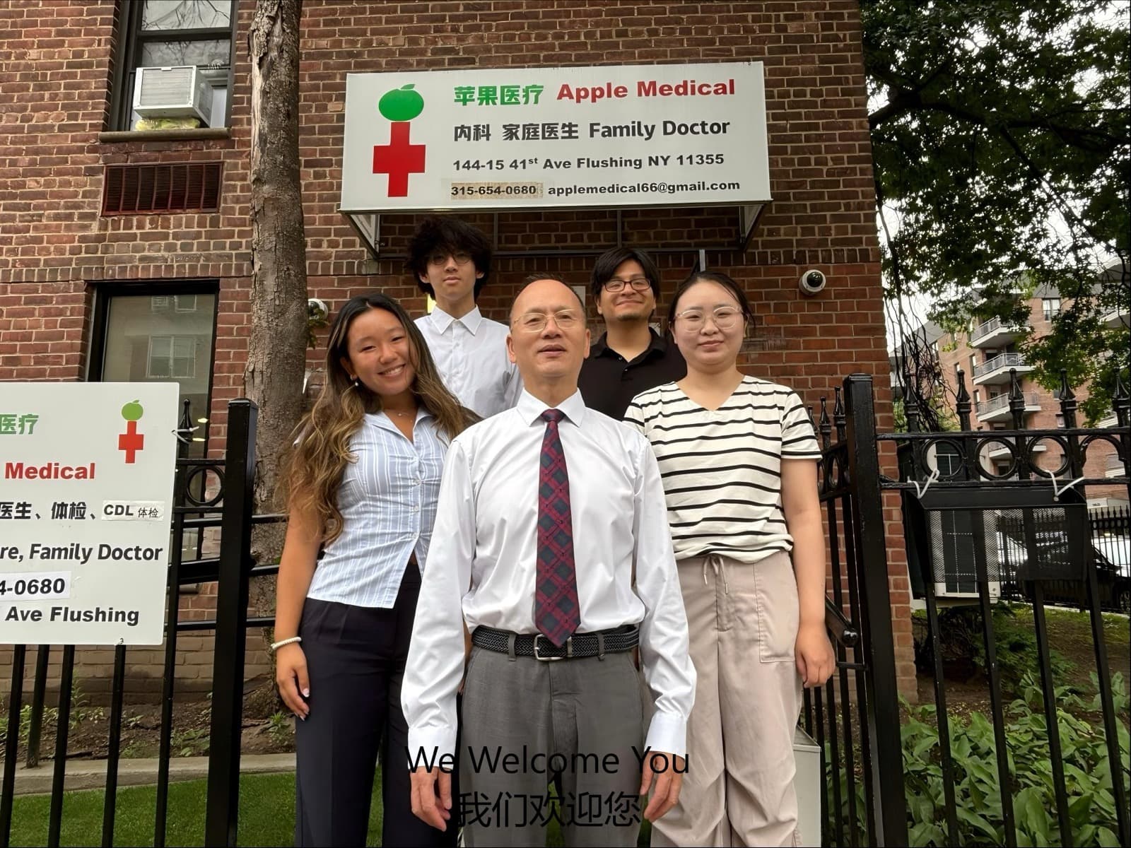 The Apple Medical team outside the clinic; a side sign lists CDL exam services
